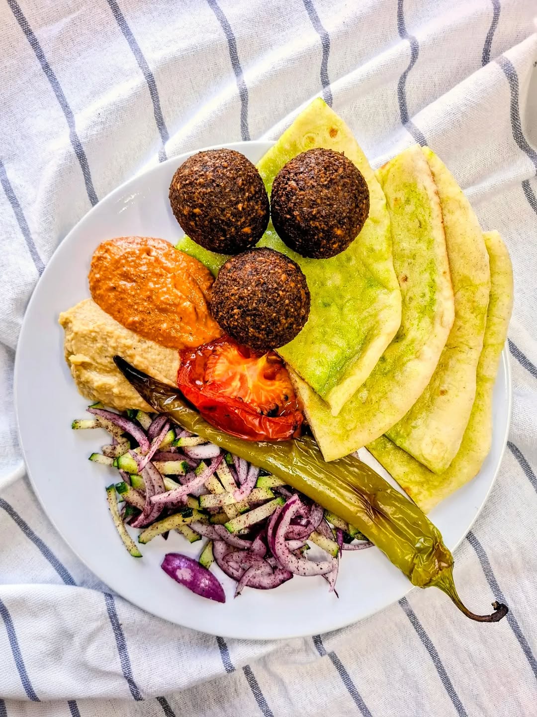 Falafel plate with hummus, muhammara and warm flatbread